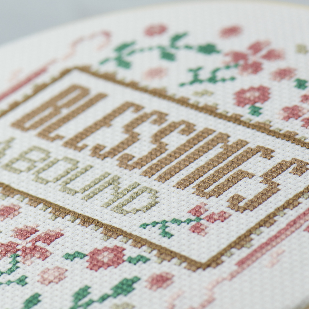 modern cross stitch words blessings abound in shades of brown with flowers