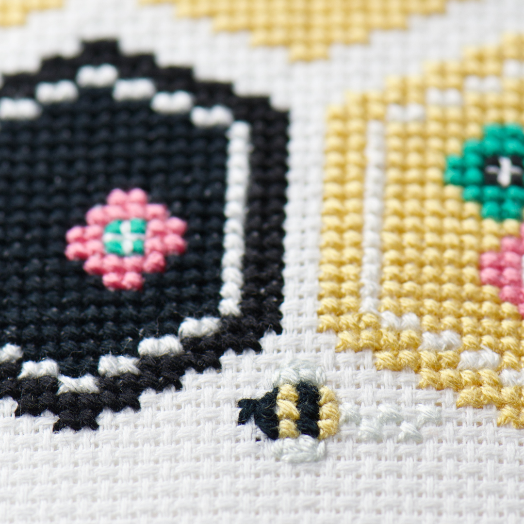 close up of cross stitch bee with simple back stitching for the beginner stitcher