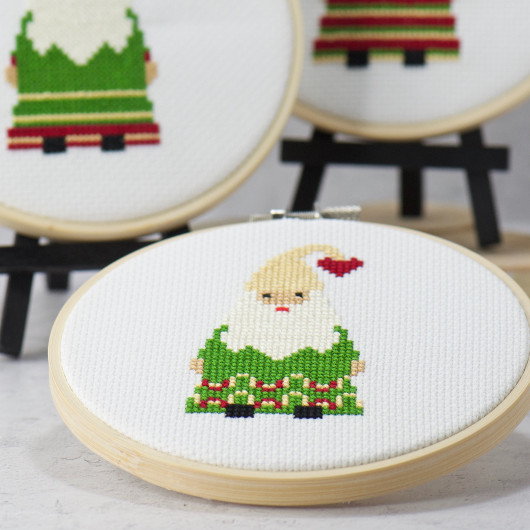 cute gnome dressed in green for christmas in wood embroidery hoop