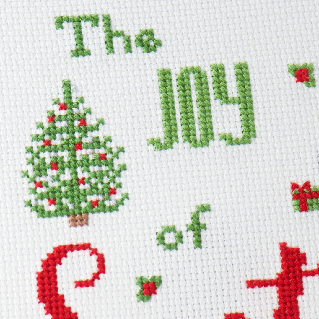 close up of cross stitch christmas tree on the joy of santa cross stitch
