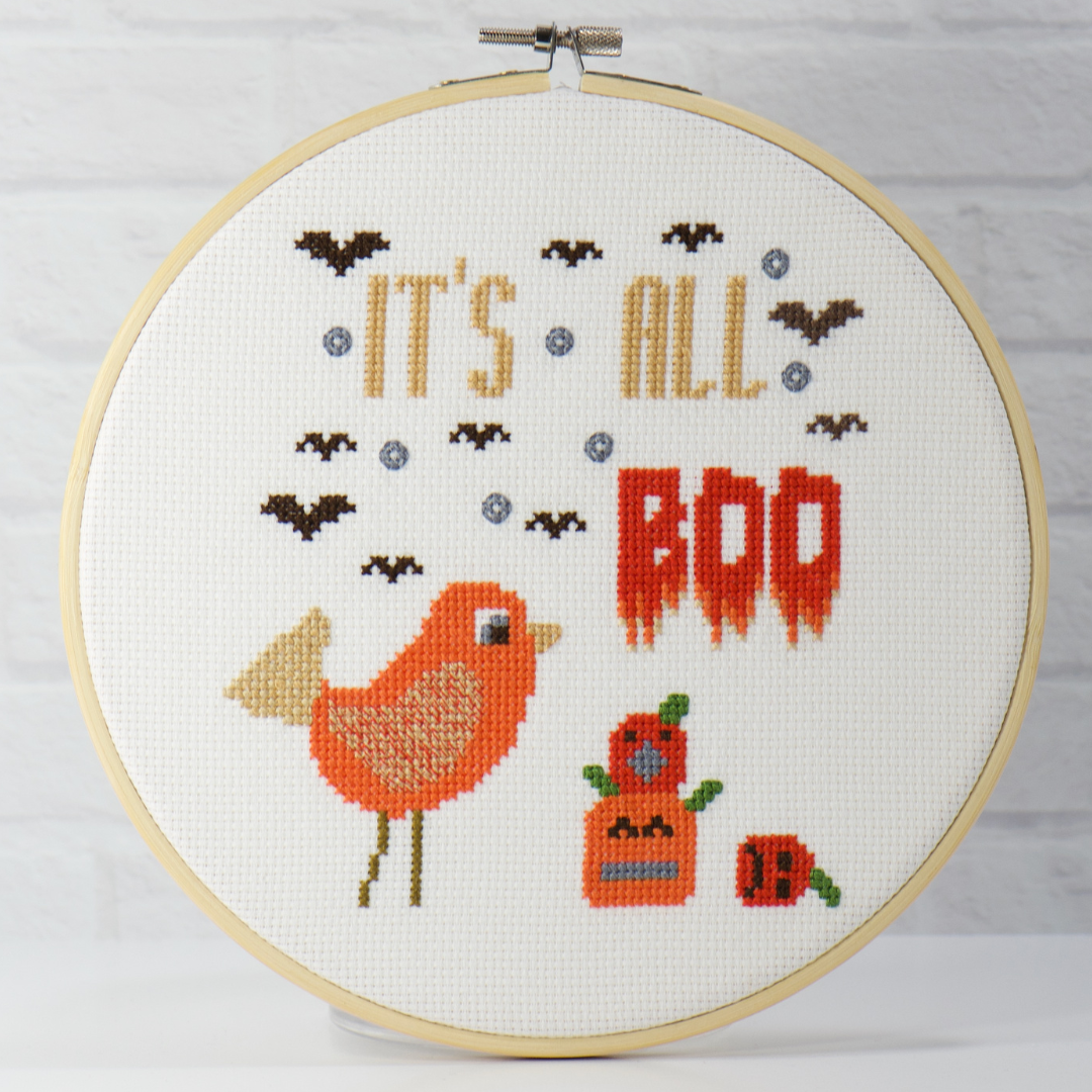 halloween counted cross stitch of frightened pumpkins, cute bird and dripping words surrounded by flying bats