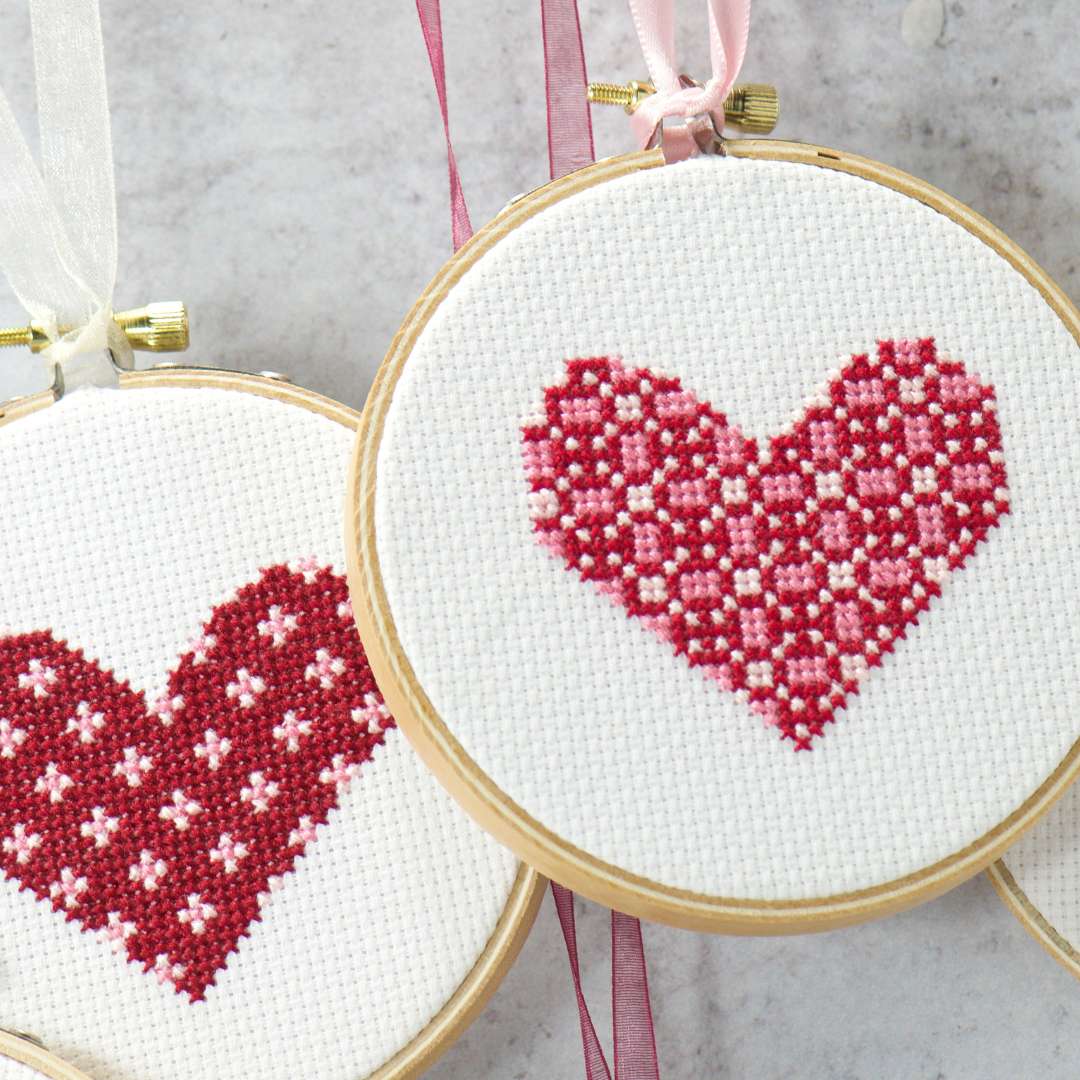 pink red hearts hanging from soft organza ribbon diy cross stitch embroidery project