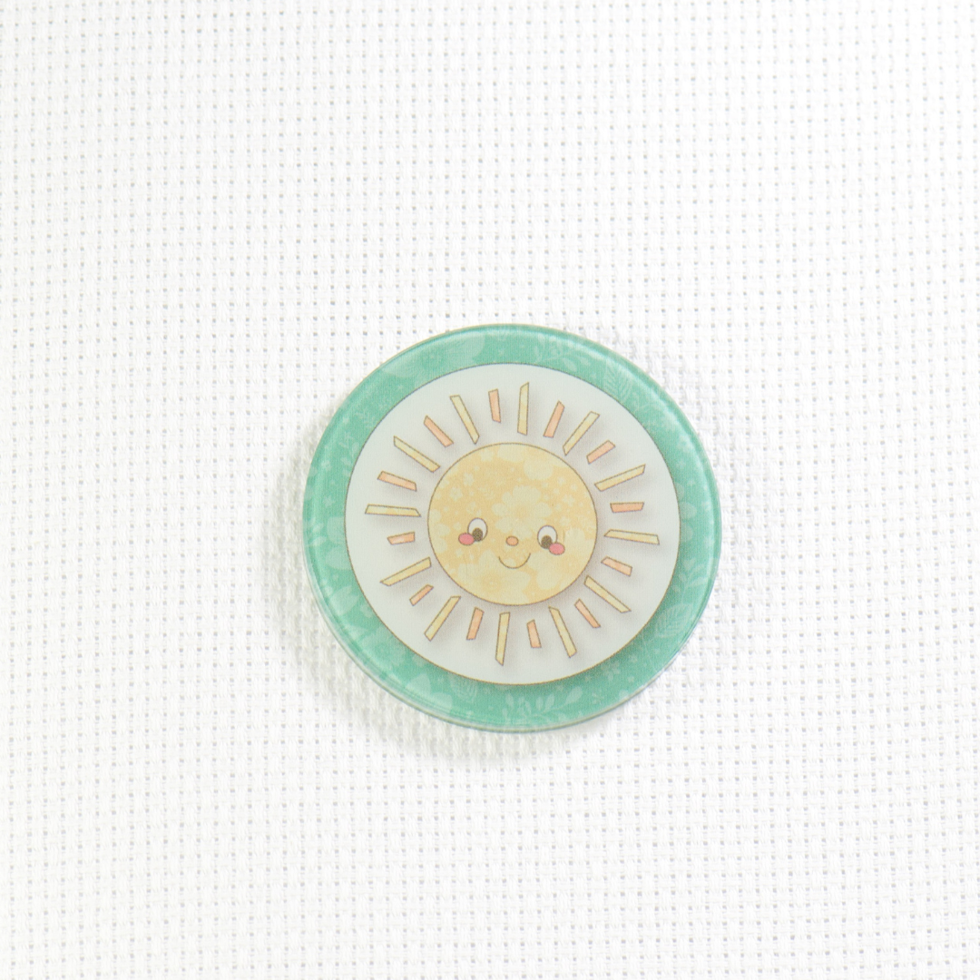Circular badge with a sun design on a white background