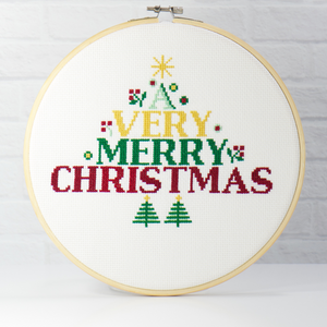 bold red, green and yellow block cross stitch letters surrounding by green embroidery trees and topped with a bright yellow star on this digital download