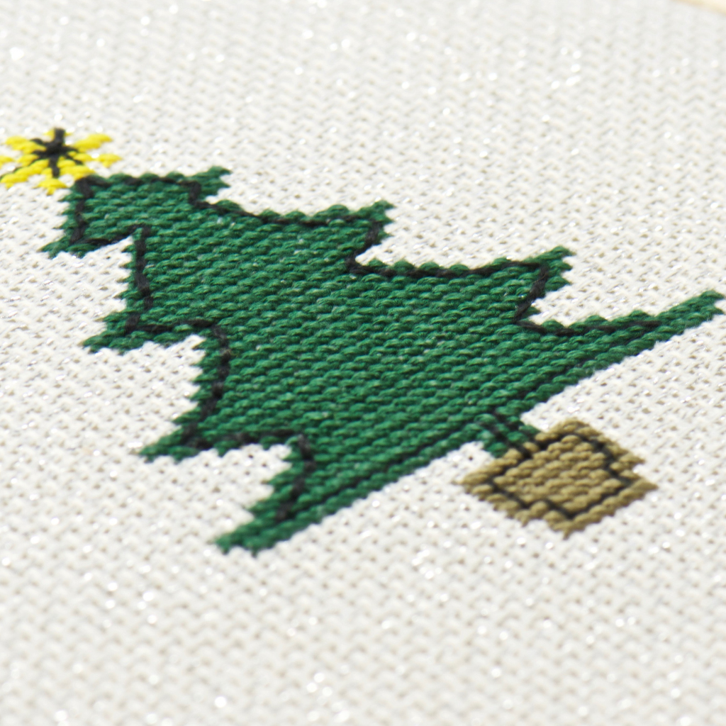 simple green christmas tree with yellow star on cross stitch pattern in this kit