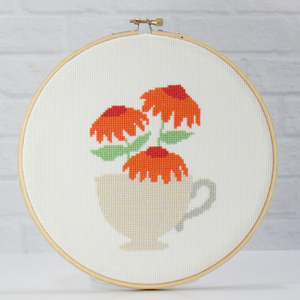 orange poppy flowers in a cream teacup cross stitch pattern
