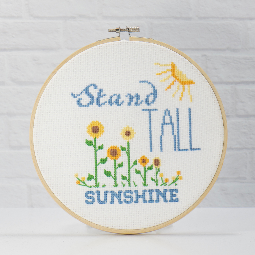 golden sunflowers with bright sun and blue words on this stand tall sunshine modern cross stitch downloadable pattern