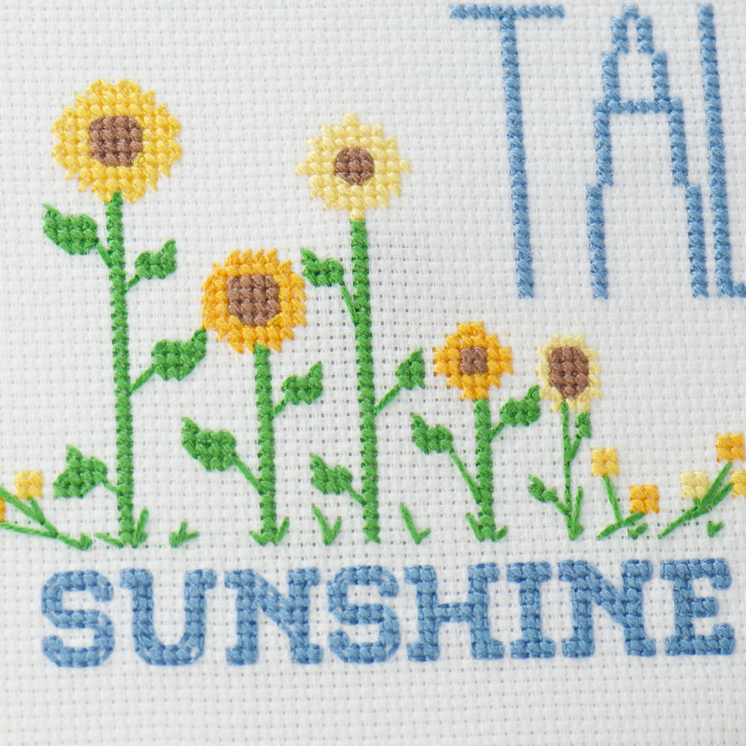 stand tall sunshine counted cross stitch pattern with gold sunflowers, sun and words in blue