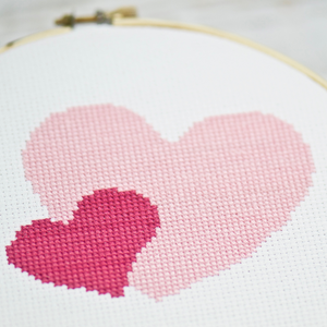 two simple cross stitch hearts in pink and rose colors for Valentine's Day