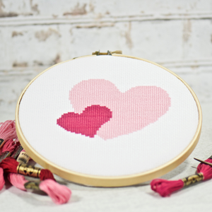 two simple cross stitch hearts in pink and rose colors for Valentine's Day